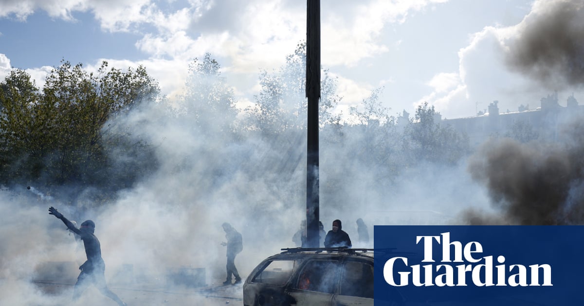 Building set ablaze and more than 1,200 arrested as police clash with protesters across France
